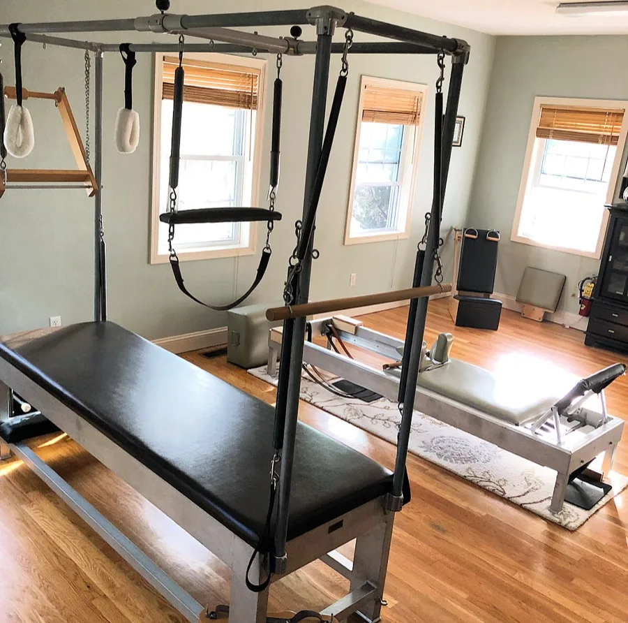 Wide view of the Pilates Room studio floor with reformers and mat equipment