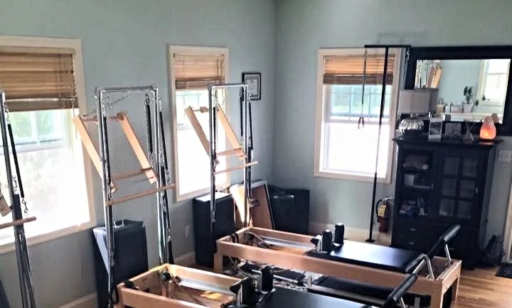 Pilates studio room with equipment and natural light